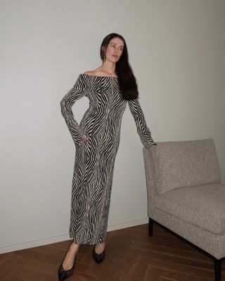 Woman wears zebra print maxi dress and black heels