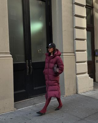 Fashion influencer @mimixn wearing a chic winter outfit styled with 2024/2025's burgundy tights trend.