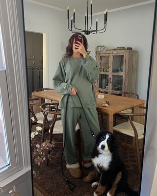 anneliese henderson mirror selfie wearing daily drills with a bernese mountain dog puppy