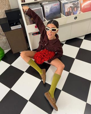 woman wearing loafers and tall socks