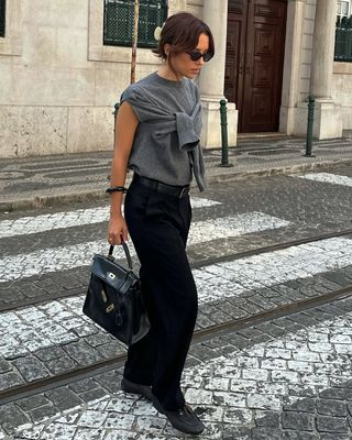 woman wearing grey sweater black pants and loafers