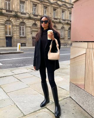 Woman wearing black riding boots.