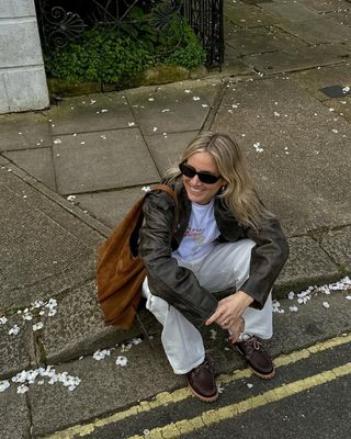 Woman wearing dark brown boat shoes.