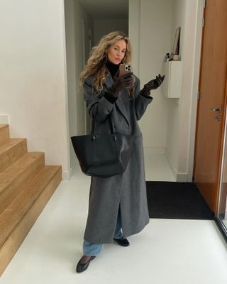 Anouk Yve in a grey coat and black Jimmy Choo bag