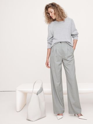 Woman wearing gray trousers with white shoes