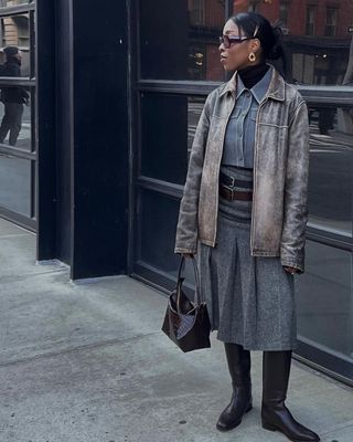 Cortne Bonilla in a denim top and skirt with riding boots.