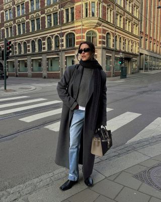 Fashion influencer @annabelrosendahl in Copenhagen wearing a polished outfit with jeans.