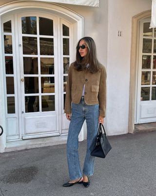 woman wearing suede jacket and jeans