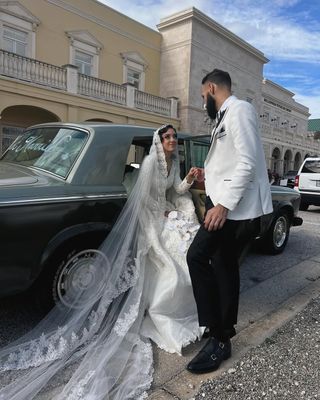 @sallyomo wearing a bridal gown with lace veil