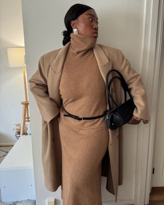 Nnenna Chem in a camel funnel neck dress and matching coat.