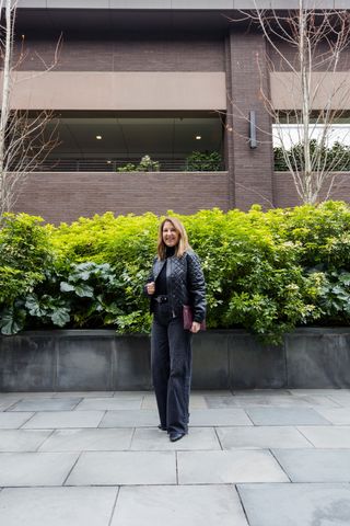 A Nordstrom stylist wearing an all-black outfit.