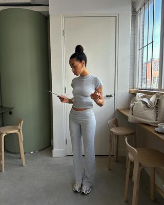 Amaka in light grey leggings