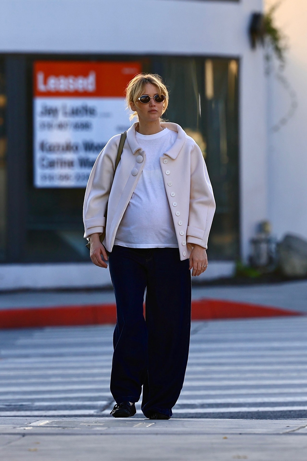 Image may contain Jennifer Lawrence Pedestrian Person Standing Clothing Pants Footwear Shoe Accessories and Glasses