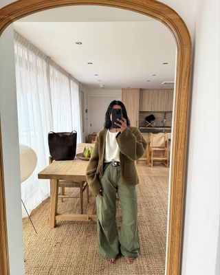 Influencer wearing olive green pants.