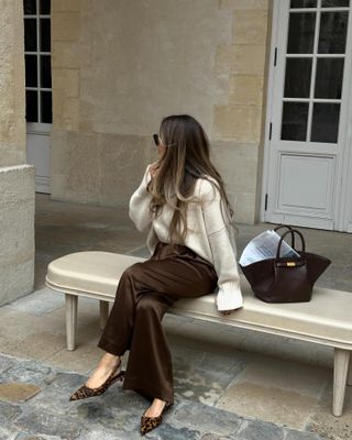 Influencer wears brown satin trousers