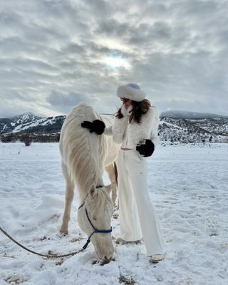 Fashion editor, Judith Jones, in white cashmere set in the snow