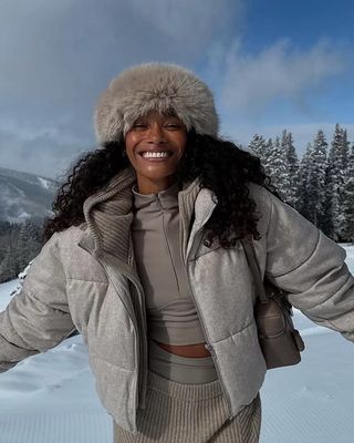 Woman in puffer coat in the snow