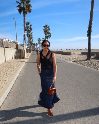 Sierra Mayhew, Who What Wear fashion editor, wearing denim skirt.