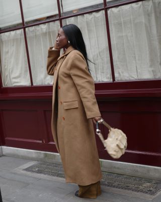 Influencer @daniellejinadu wears a cashmere coat.