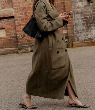 An image of Who What Wear UK's SEO Writer Ava Gilchrist wearing a cashmere coat during fashion week.