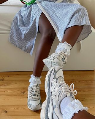 Influencer wears Asicas trainers.