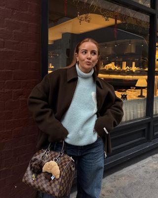 @rebeccaferrazwyatt wears a light blue jumper with a brown coat and jeans