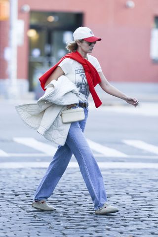 Gigi Hadid wears jeans and clogs.