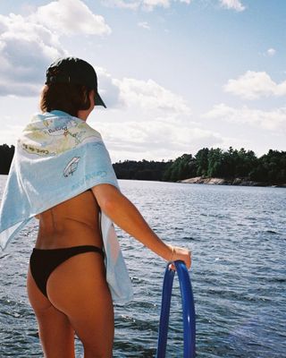 woman wearing black bikini bottoms by lake