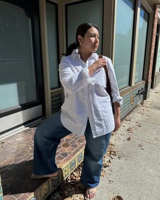 Woman wears white t-shirt, blue jeans