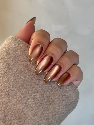 A cinnamon glaze manicure for Hailey Bieber by Zola Ganzorigt.