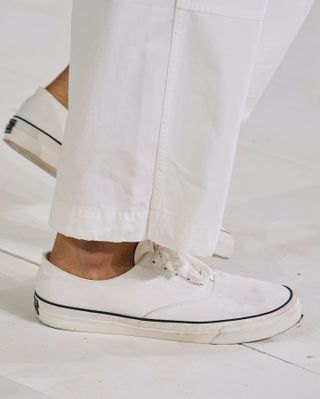 Model wearing Ralph Lauren sneakers.