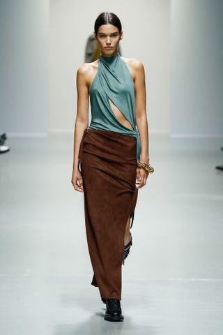 Model wears a blue top and brown skirt on the Atlein spring/summer runway 2025.