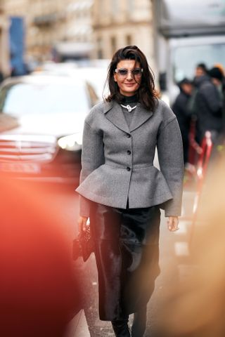 Paris Couture Fashion Week Street Style. Show attendee wears a peplum jacket.