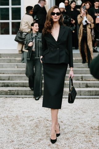 Paris Couture Fashion Week Street Style. Show attendee wears a peplum jacket.