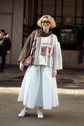 Copenhagen Fashion Week attendee wears Nike Cortez trainers.