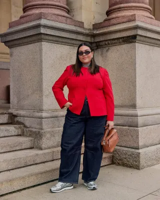 Ana wears a red top, barrel leg jeans, brown loewe bag, and retro nike sneakers.