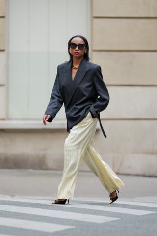 An image of influencer Emilie Joseph wearing shoes with satin trousers.