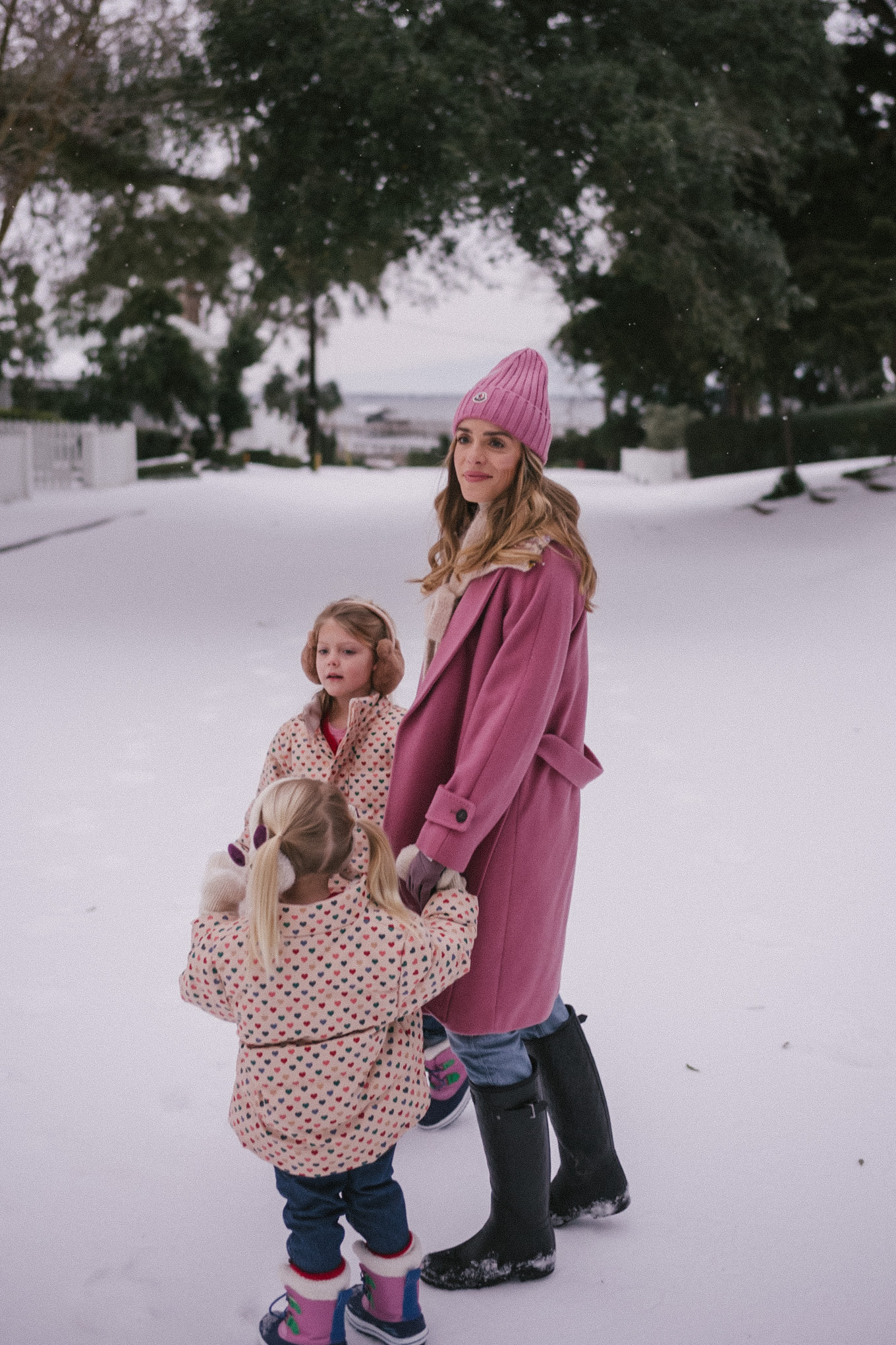 pink wool coat pink beanie blue denim snow gear