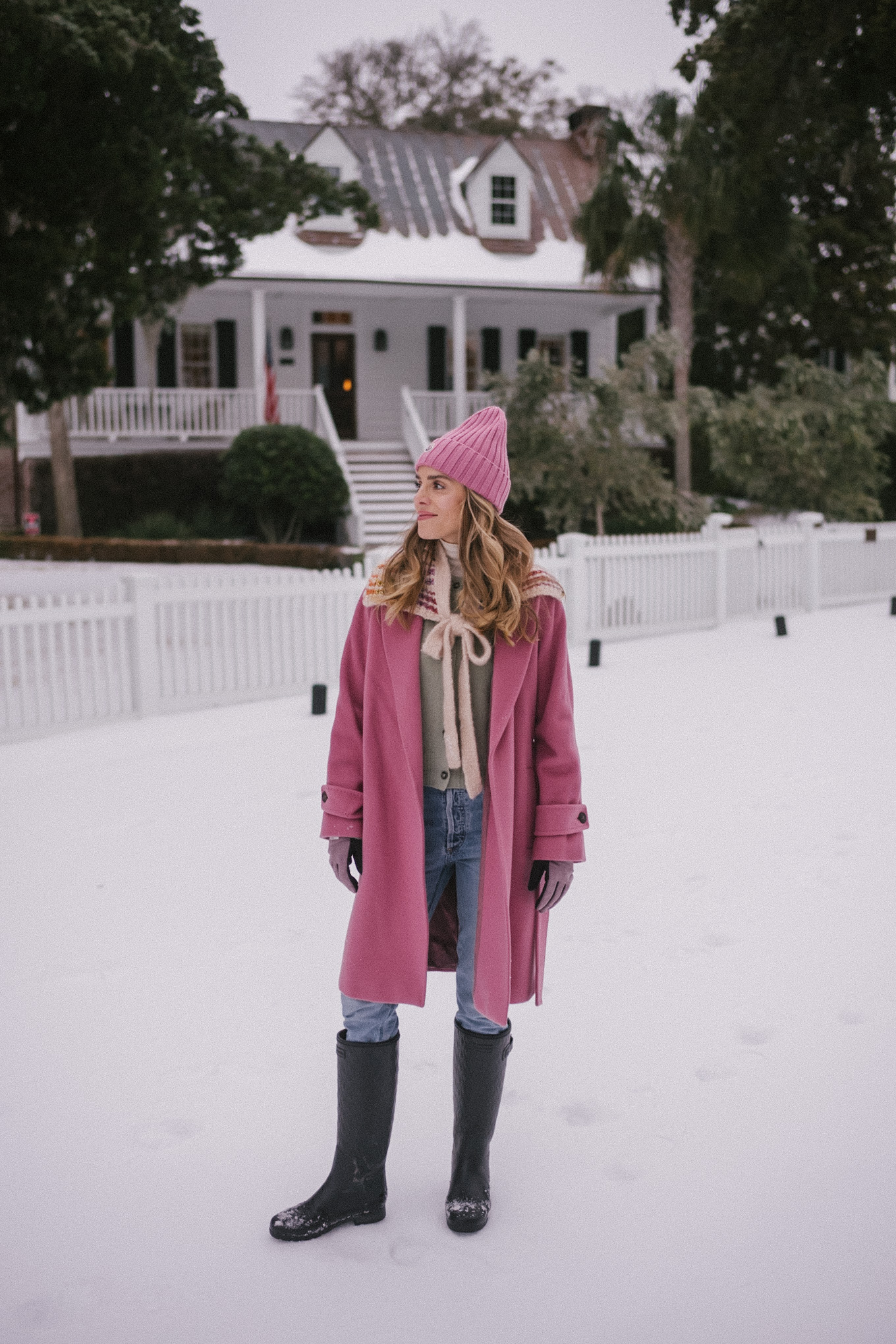 pink wool coat pink beanie blue denim snow gear