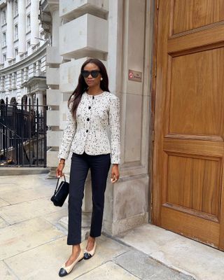 Woman wears boucle jacket and black trousers