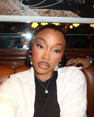 Uche Natori wearing concealer lips trend.