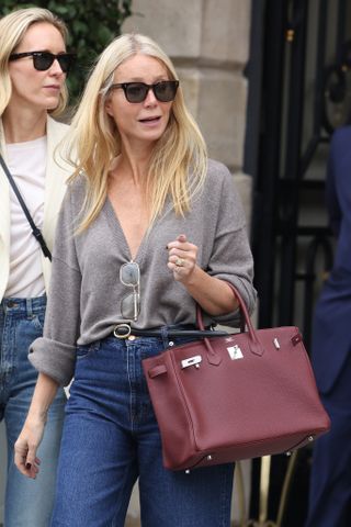 Gwyneth Paltrow wearing a gray V-neck sweater.