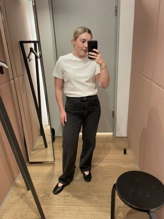 Woman wears white t-shirt and black jeans