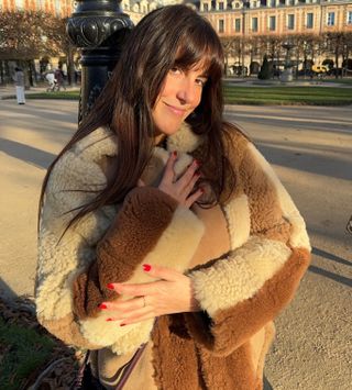 French fashion influencer @dianekari wearing a chic outfit featuring staple Parisian fashion items for 2025, including a faux-shearling jacket.