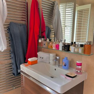 Photo of perfumes on a bathroom shelf