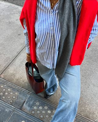 woman wearing cuffed denim outfit with striped button down shirt