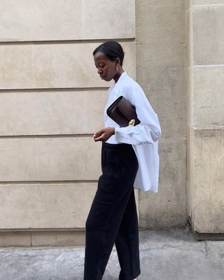 @sylviemus_wearing a white shirt and black trousers