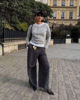 Influencer wears wrap trousers.