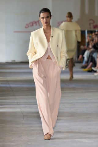 Spring Trouser Trends 2025: A model walks the Rachel Comey runway in pink trousers