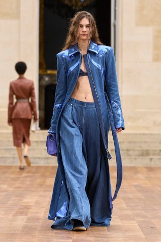 Spring Trouser Trends 2025: A model wears a pair of ultra-wide jeans on the Gabriela Hearst runway